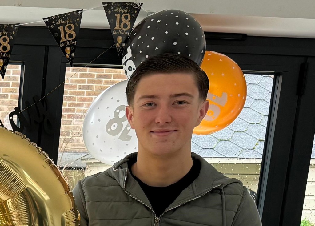 Henry Nowak, an 18-year-old student, smiling in front of