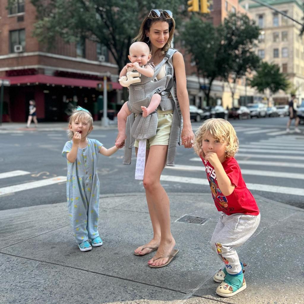 Hilaria Baldwin with her three children in a city setting.