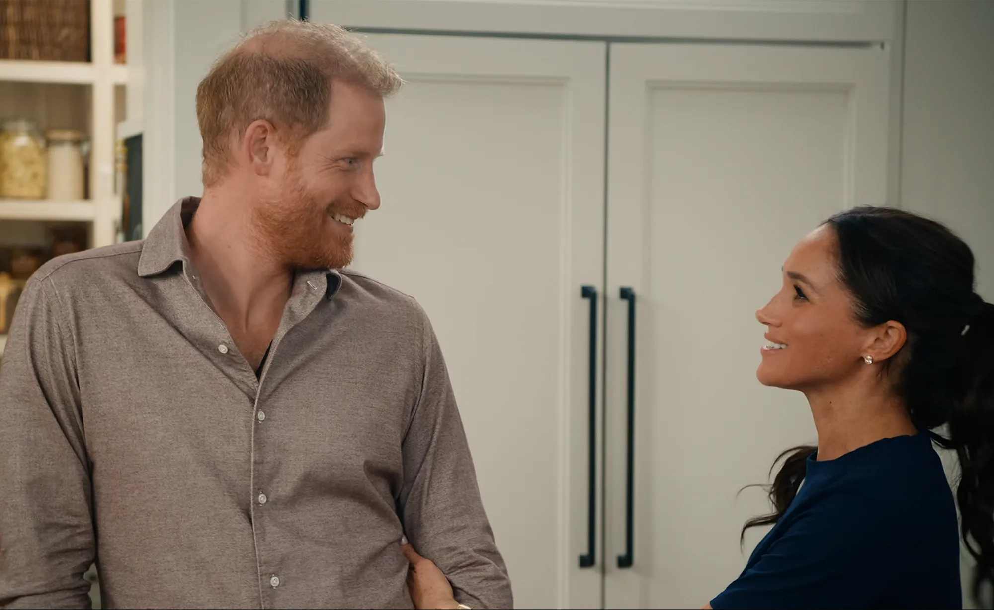 Prince Harry and Meghan Markle looking at each other and smiling.