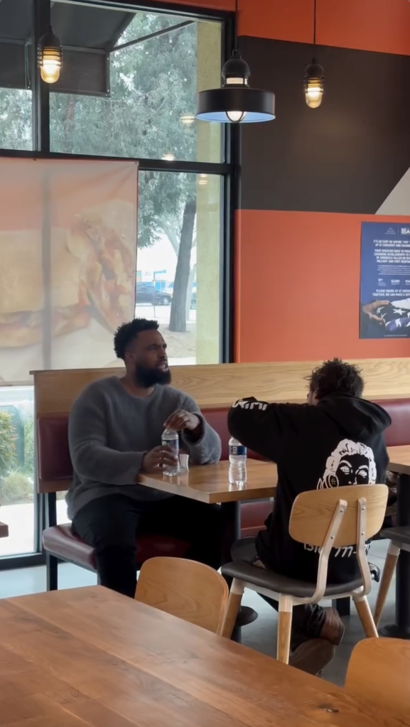 Two people eating pizza.