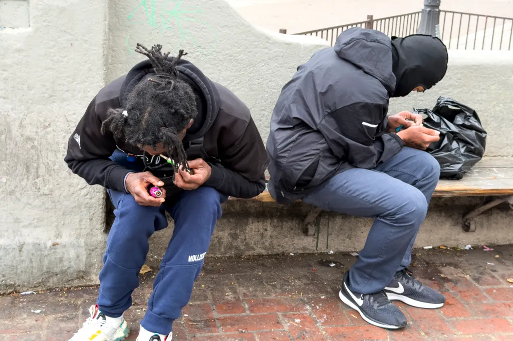Two homeless people at MacArthur Park in Los Angeles.