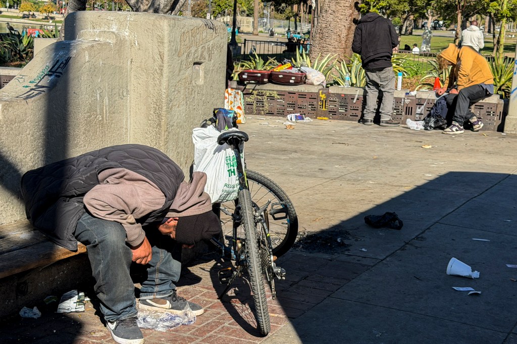 Homeless people resting at MacArthur Park in Los Angeles.