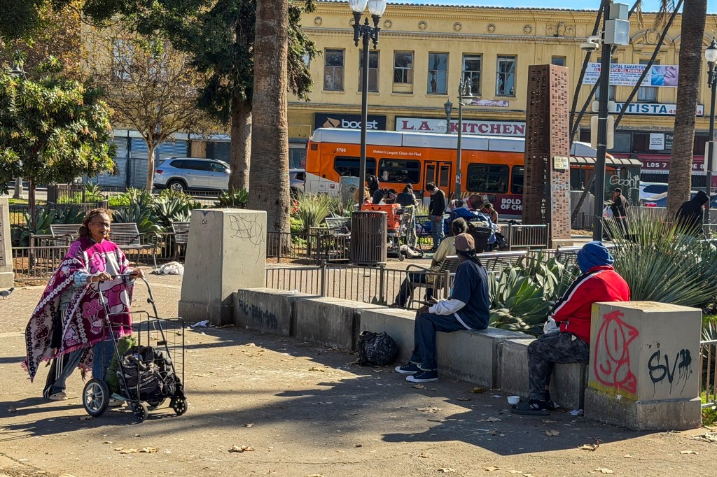 Homeless people rest at MacArthur Park.