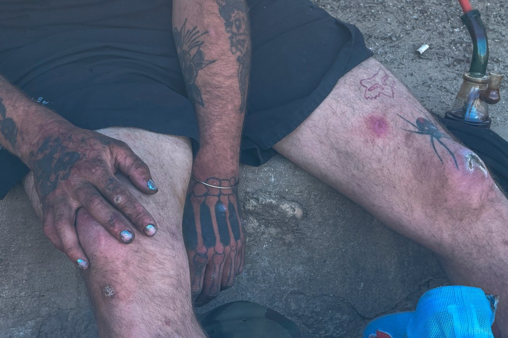Homeless person resting in MacArthur Park.