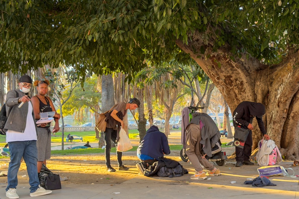 Homeless people resting at MacArthur Park in Los Angeles.