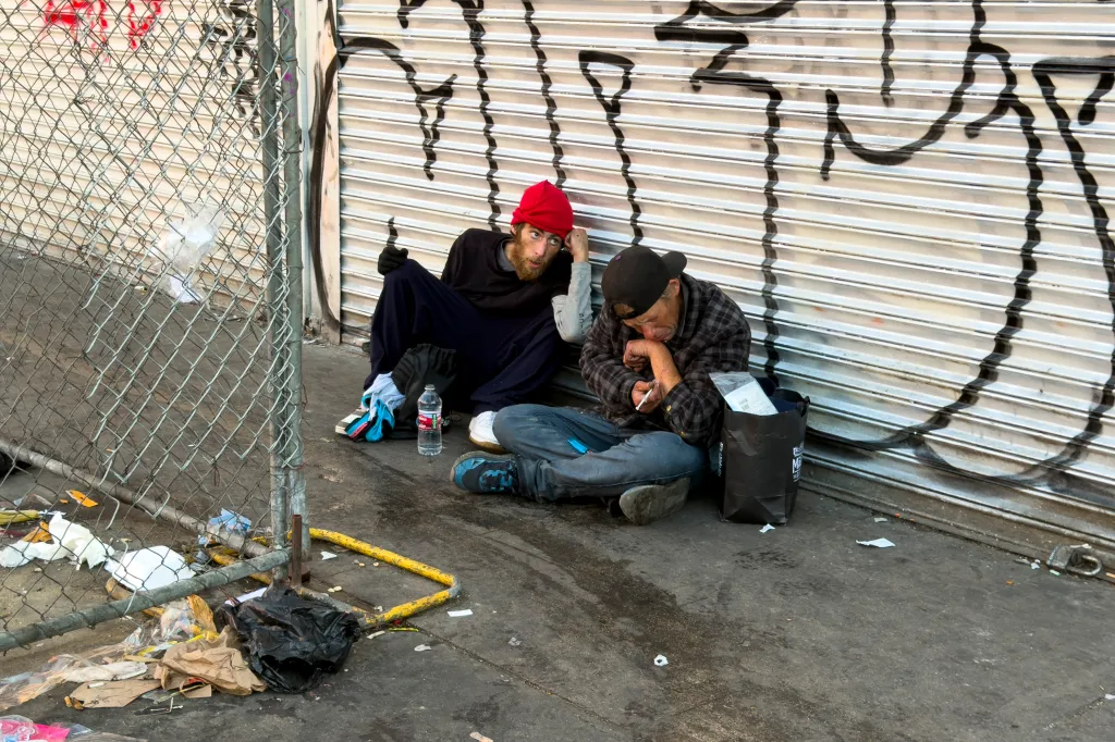 Two homeless people resting at MacArthur Park.