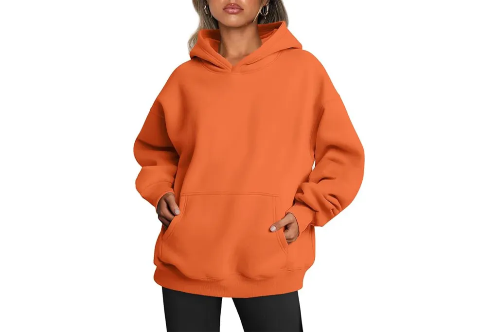 A woman wearing an orange sweatshirt