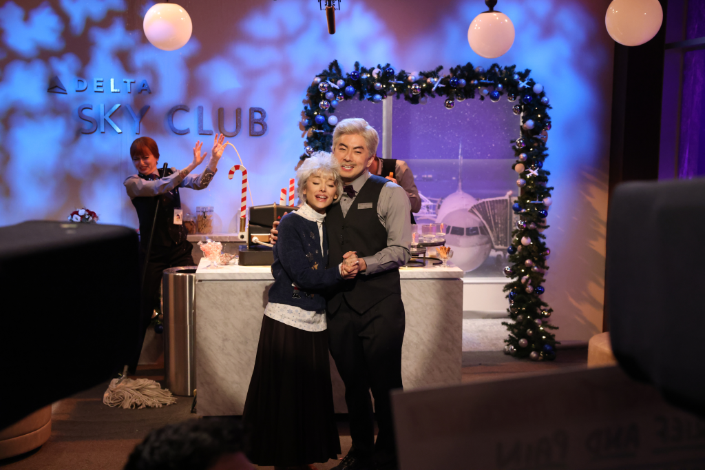 Ariana Grande and Bowen Yang posing during the 