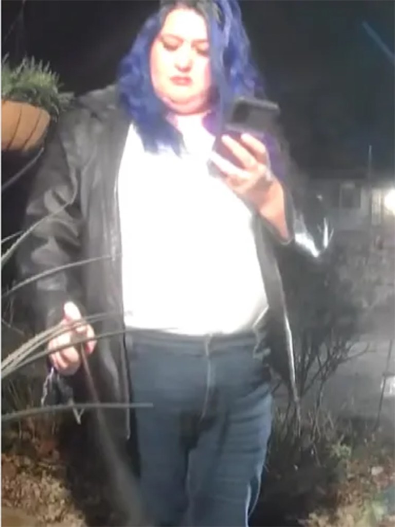 Stevenson spraying a bag of food with pepper spray while looking at her phone.