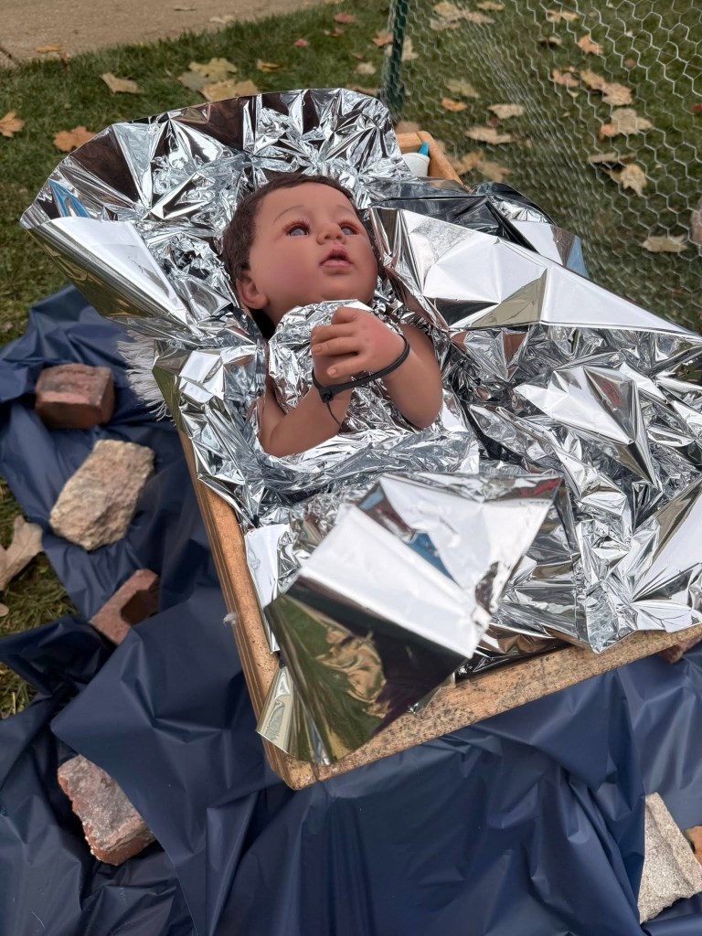 Baby Jesus is wrapped in a thin blanket resembling aluminum foil, which the church said is a reference to the emergency blankets used in detention facilities.