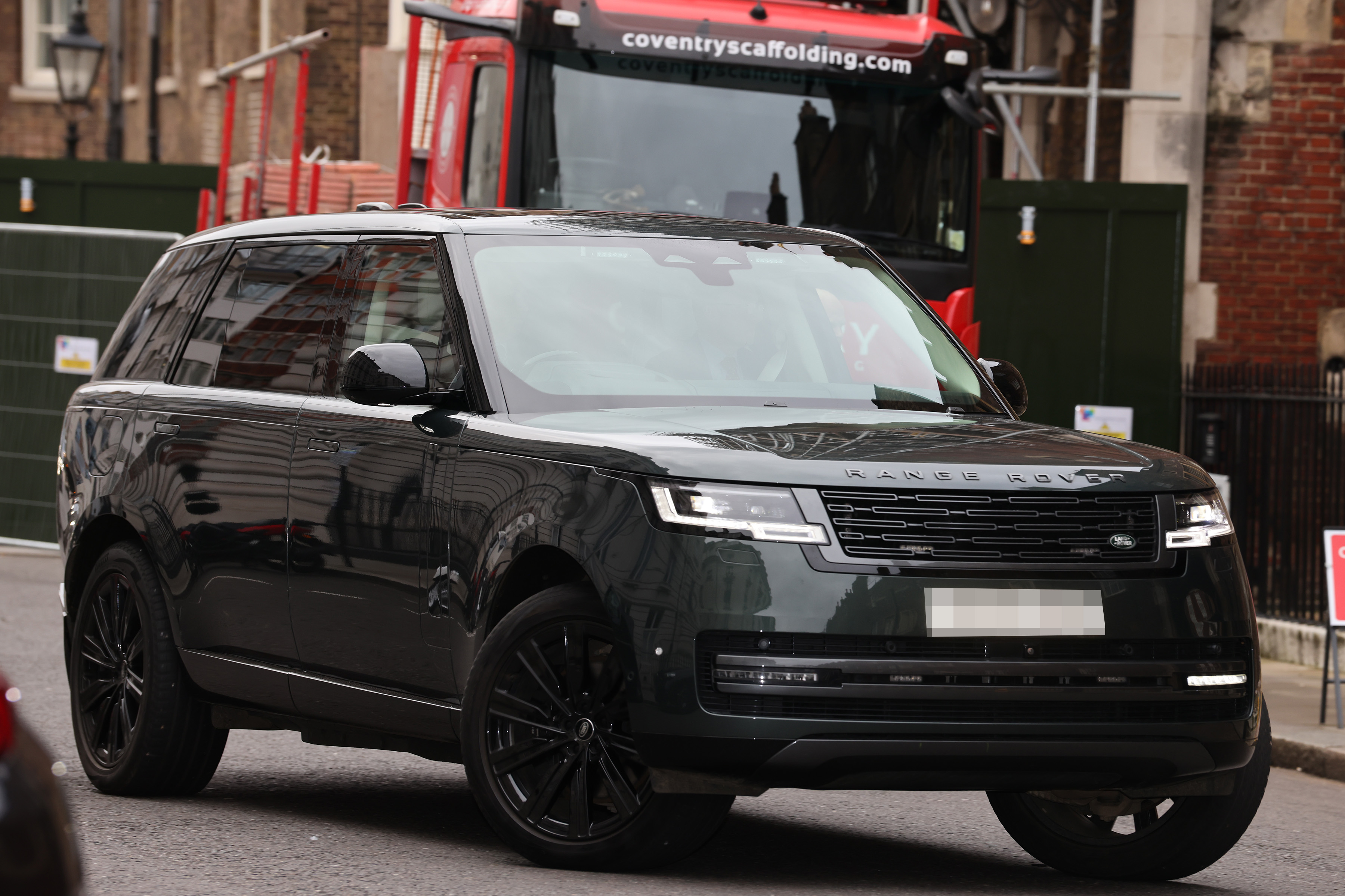 A black Range Rover with a pixelated license plate arrives for the Christening of Athena Mapelli Mozzi.