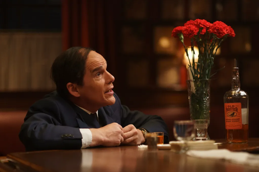 Ethan Hawke at a table with a bottle of Old Frontier bourbon.