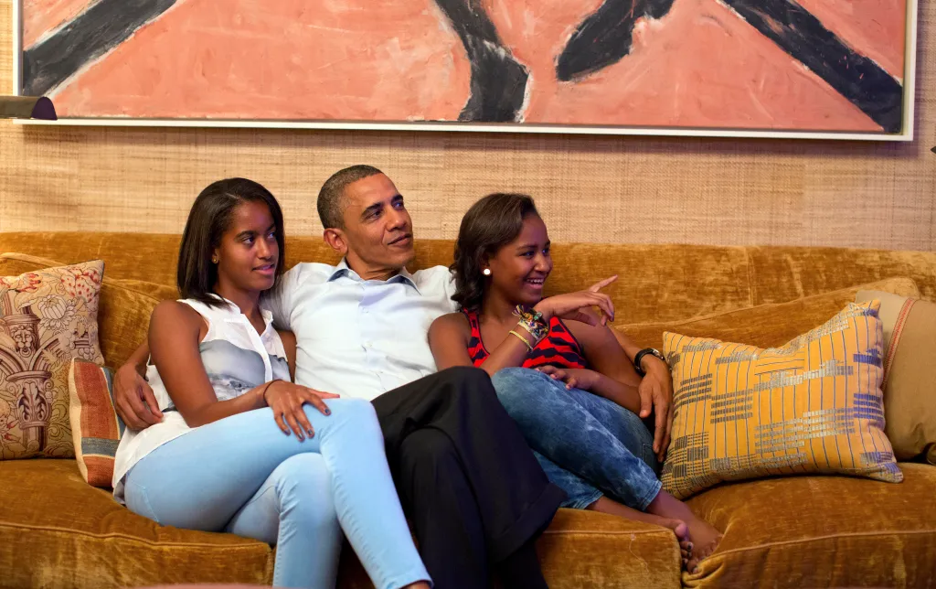 President Barack Obama and his daughters, Malia and Sasha, watch the Democratic National Convention on TV.