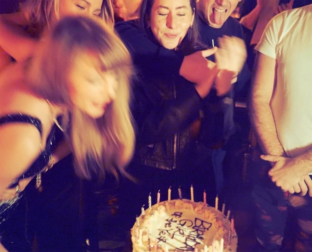 Taylor Swift blowing out her birthday candles.