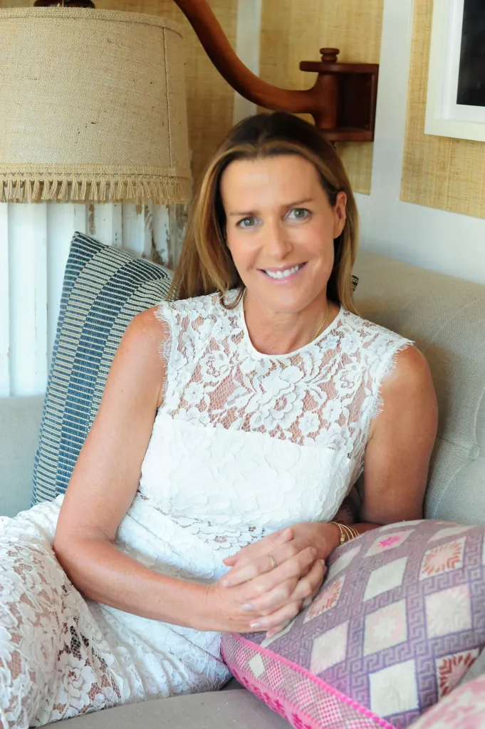 India Hicks smiles while sitting on a couch.