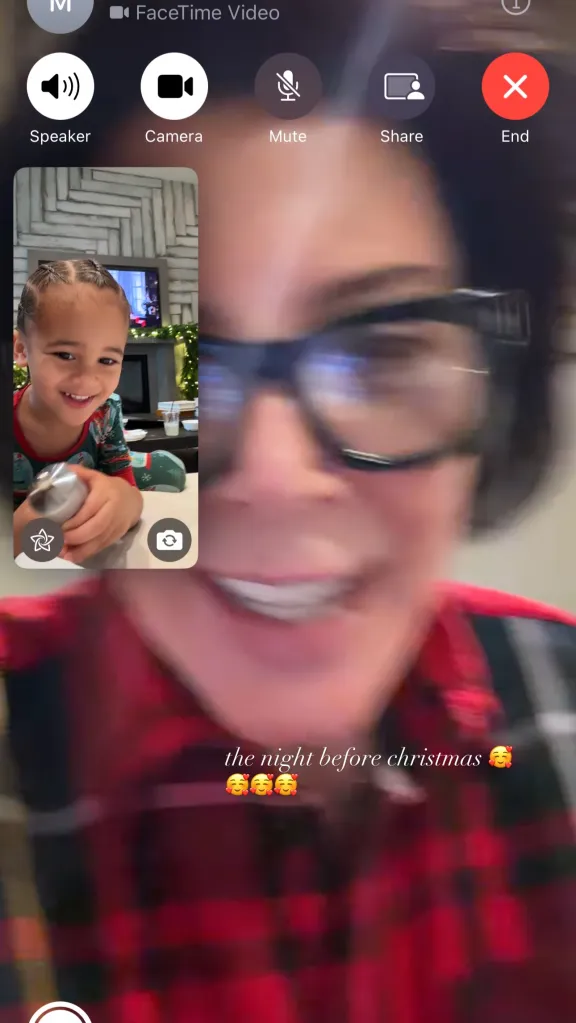 A blurred image of a woman with glasses video calling a young child.