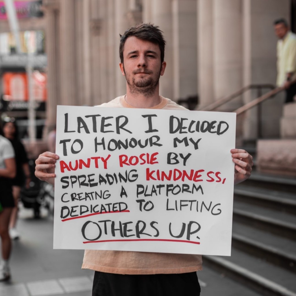 Man holding a sign that says 
