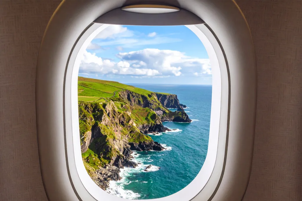 View of cliffs of Ireland through an airplane window