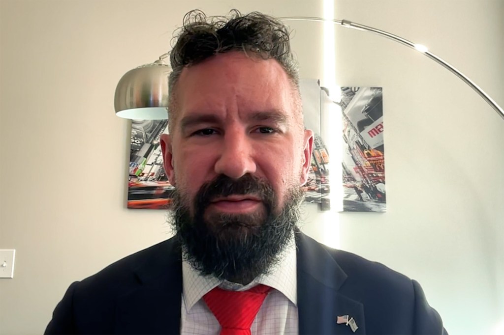 Joseph Ziegler, an IRS whistleblower, wearing a suit and red tie.