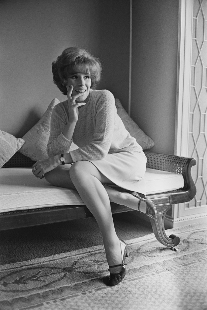 Italian singer Ornella Vanoni posing on a couch.