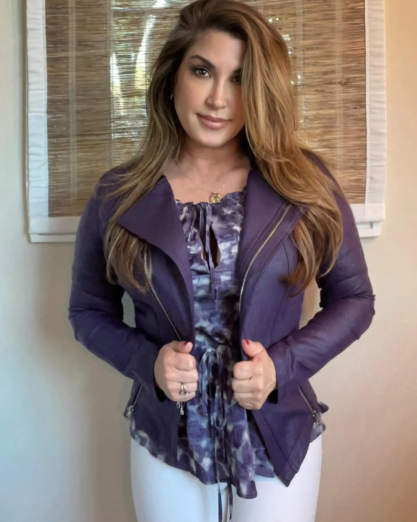 Jacqueline Laurita in a purple jacket and tie-dye top.