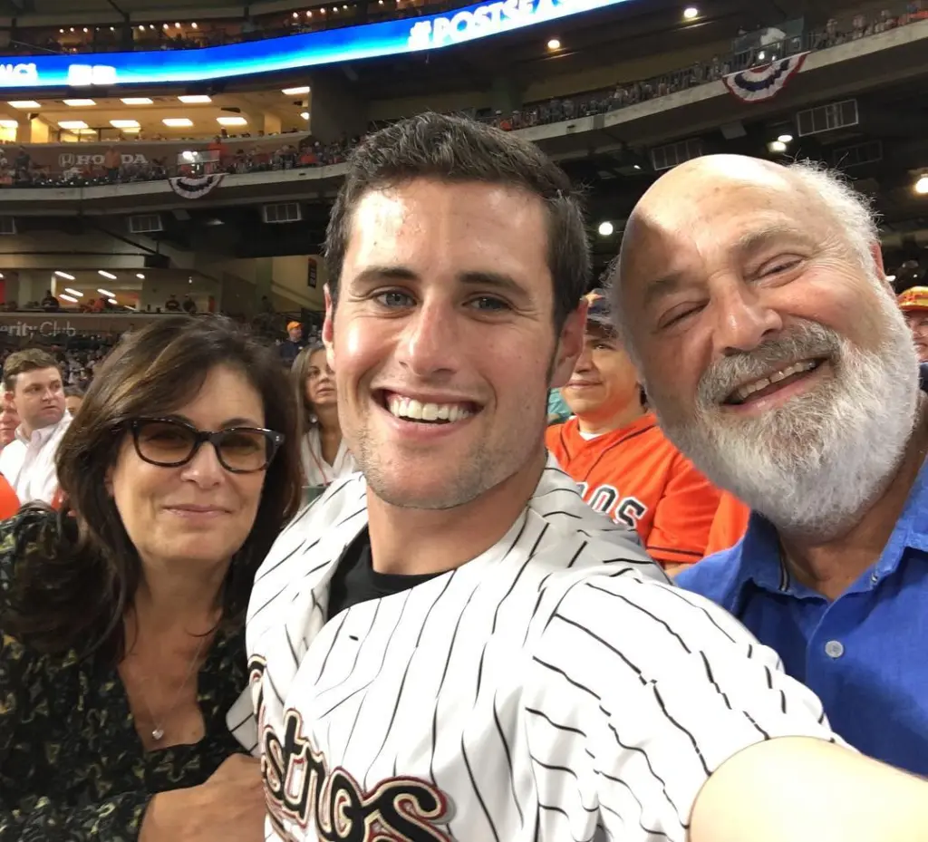 Jake Reiner with Michele and Rob at a baseball game.