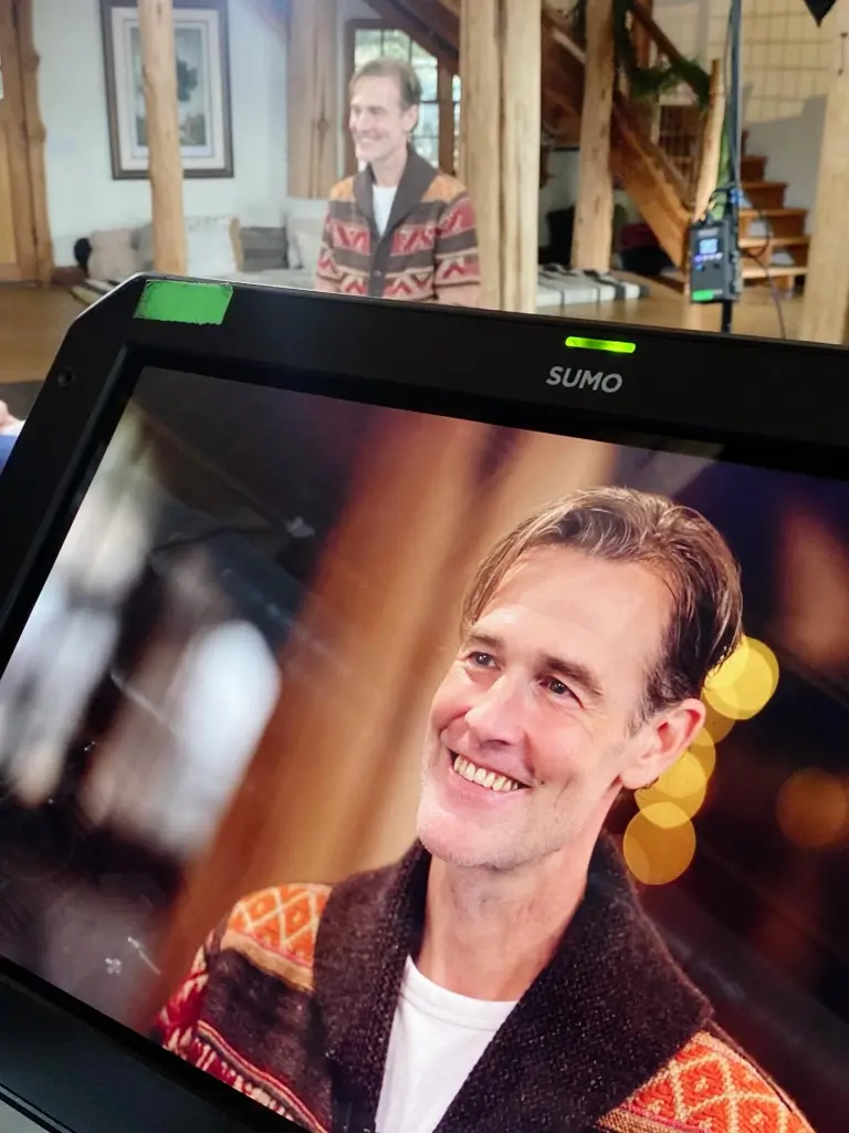 James Van Der Beek is shown on a monitor during an interview about his cancer journey.