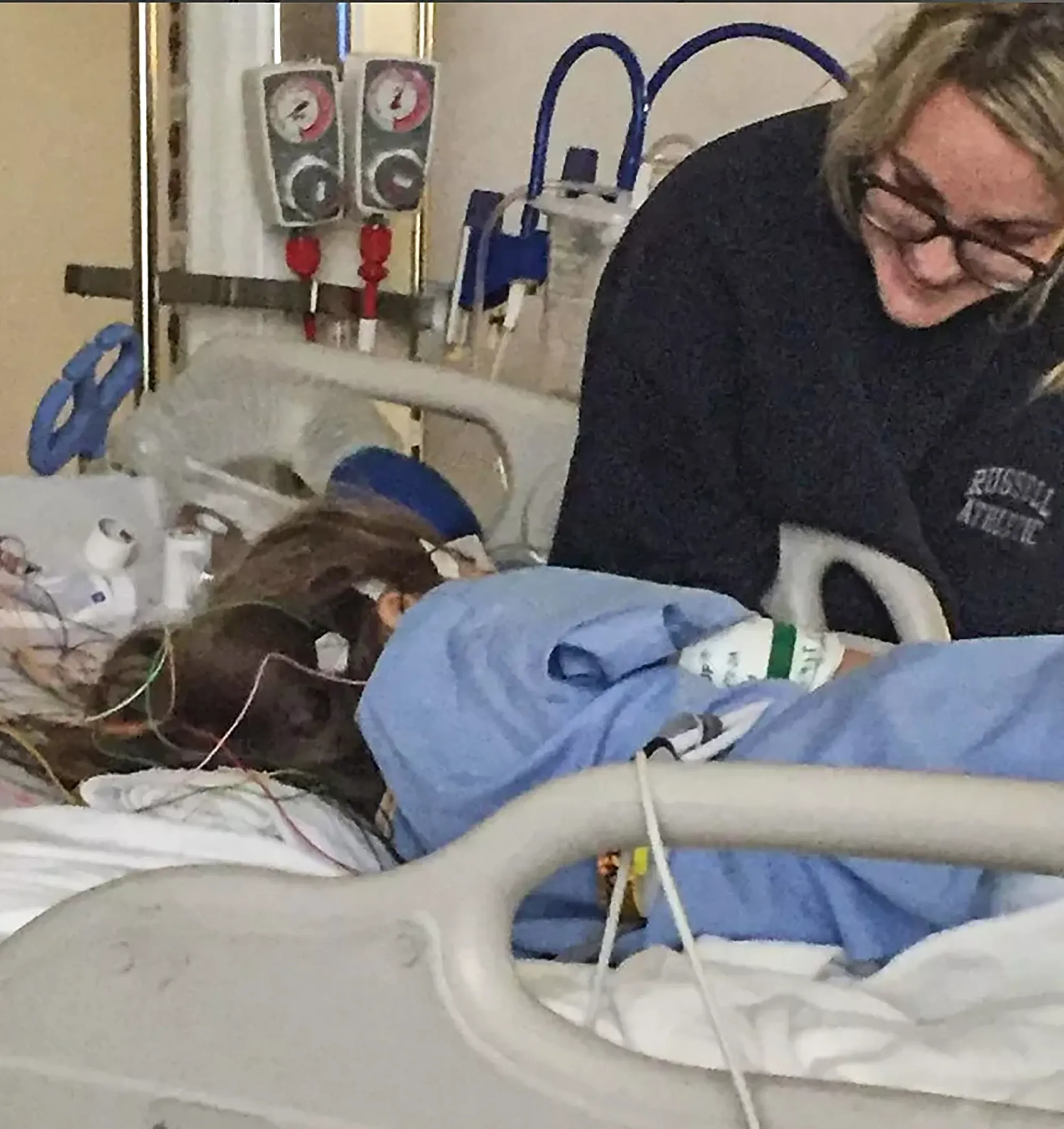 Jamie Lynn Spears looking at her daughter Maddie in a hospital bed.
