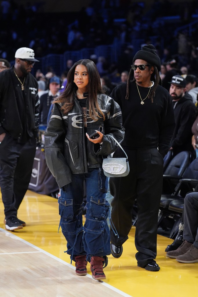 Jay-Z and his daughter Blue Ivy Carter leave an NBA Cup basketball game.