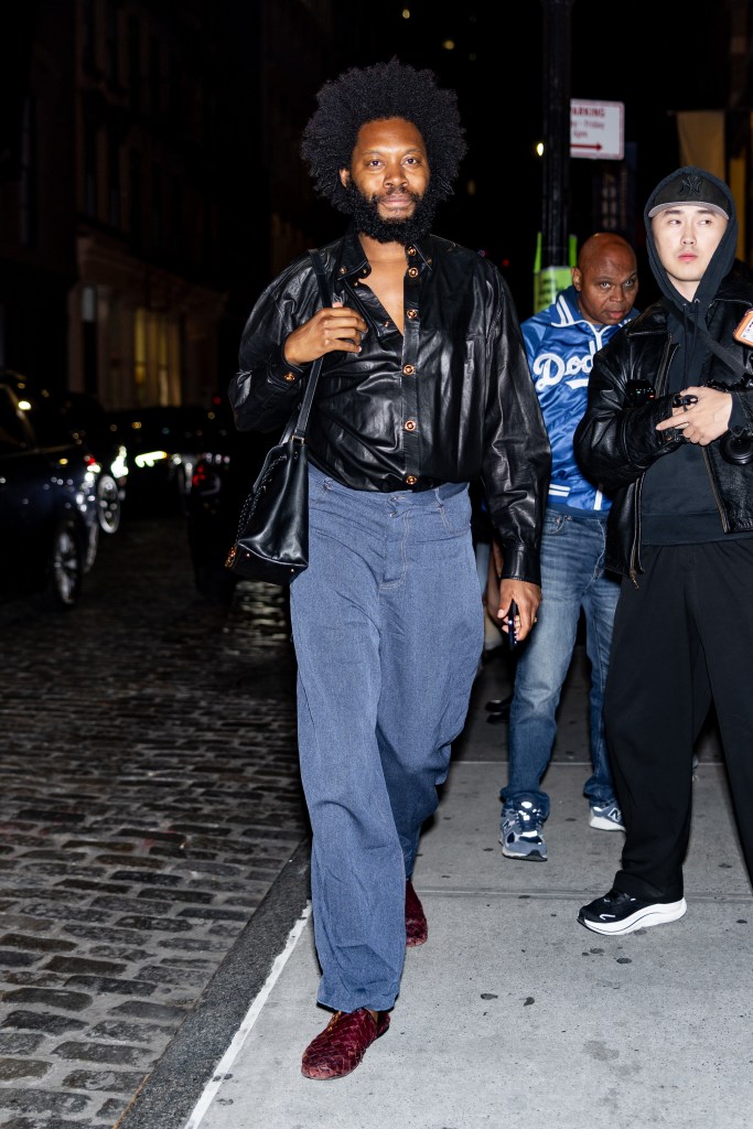 Jeremy O. Harris walking on a sidewalk at night.