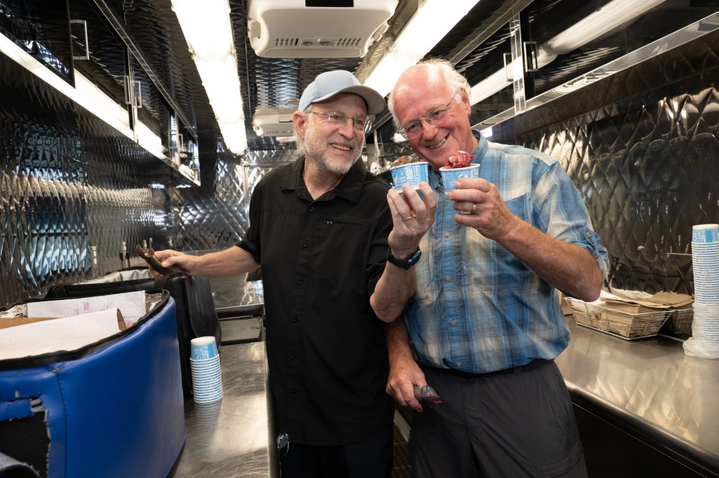 Jerry Greenfield and Ben Cohen with ice cream cups at their 