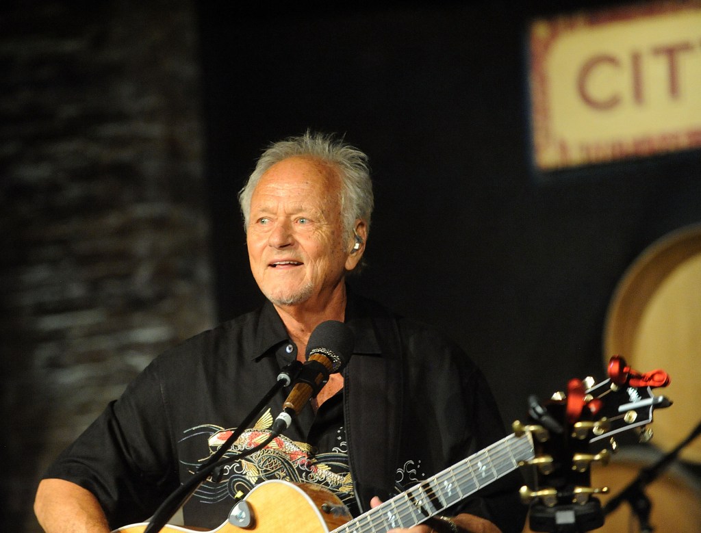 Jesse Colin Young performing with a guitar at a concert.