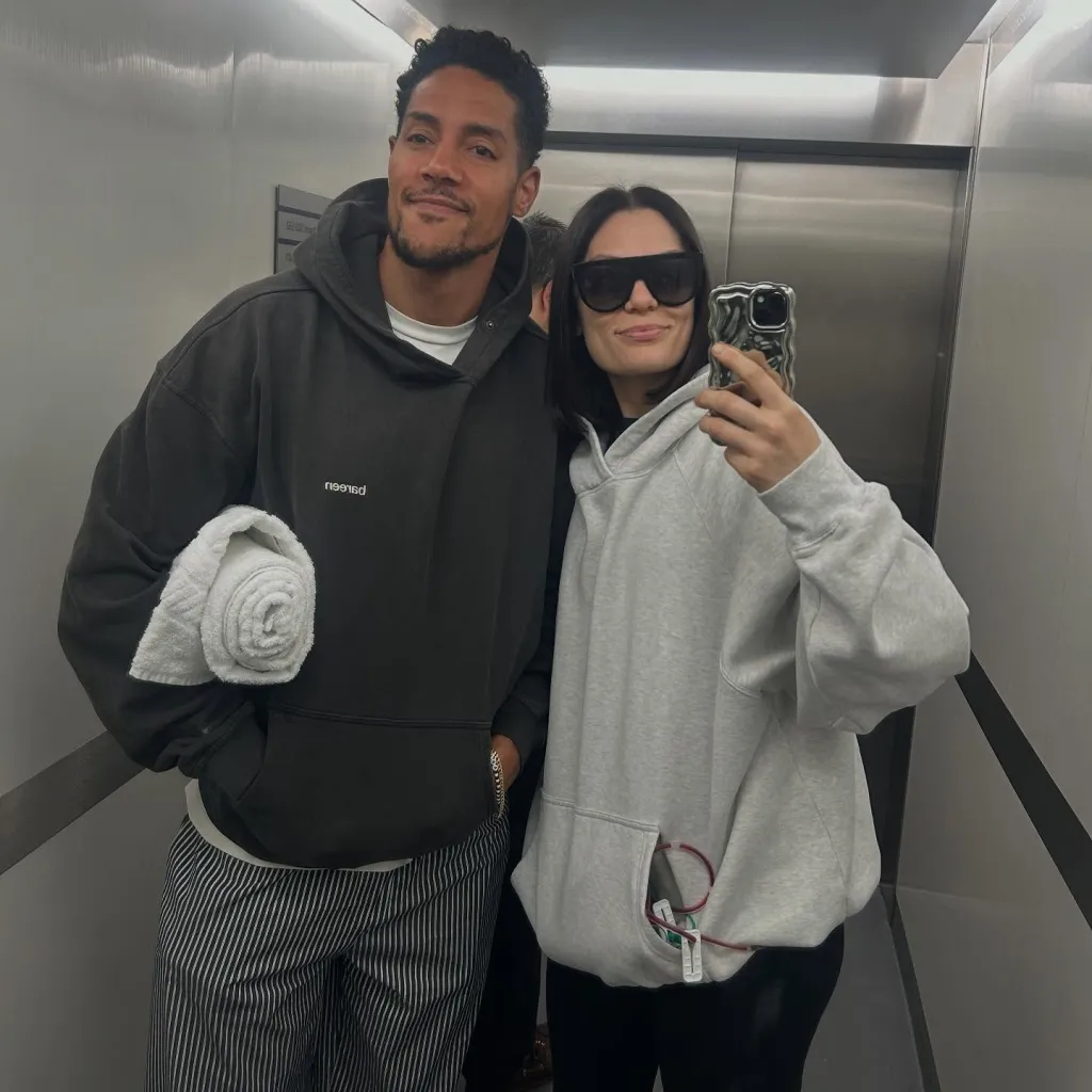 Jessie J and Chanan Safir Colman posing in an elevator, with Jessie J's post-surgery drain visible.