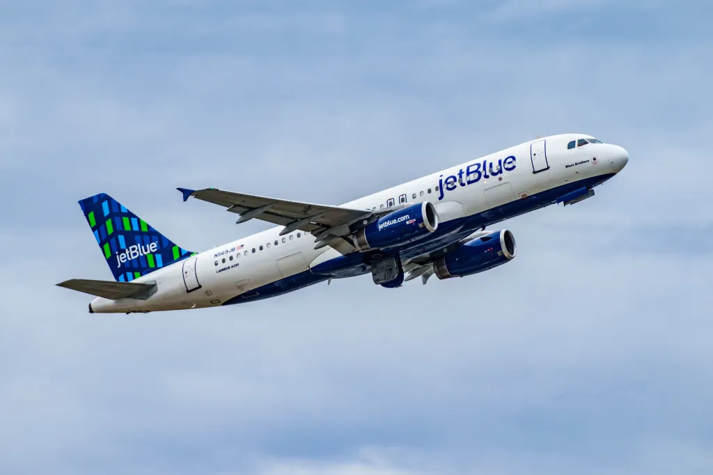 JetBlue plane in clear blue sky