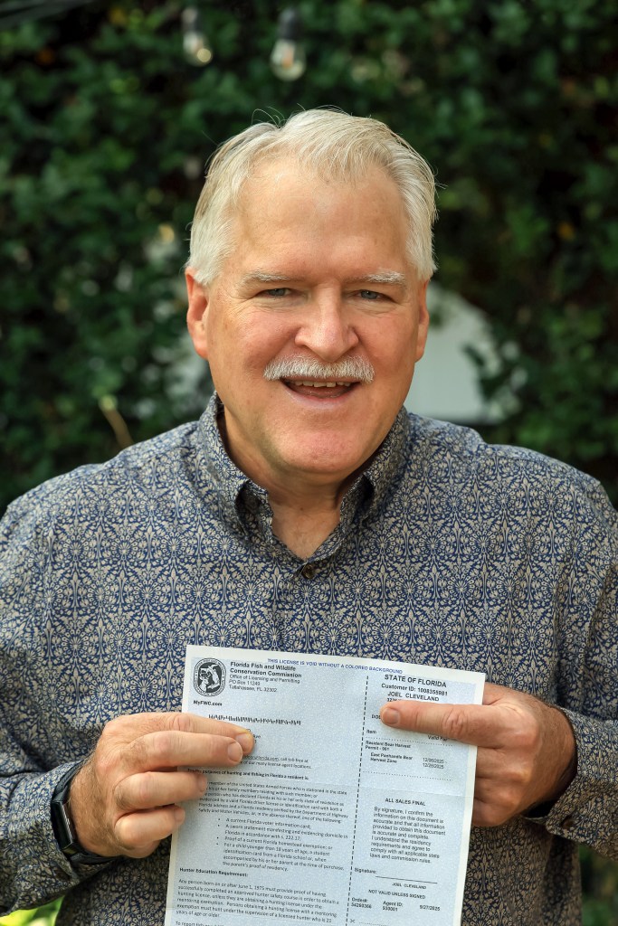 Florida resident Joel Cleveland smiles while showing off his Florida bear hunting permit in Tampa on Dec. 5, 2025.