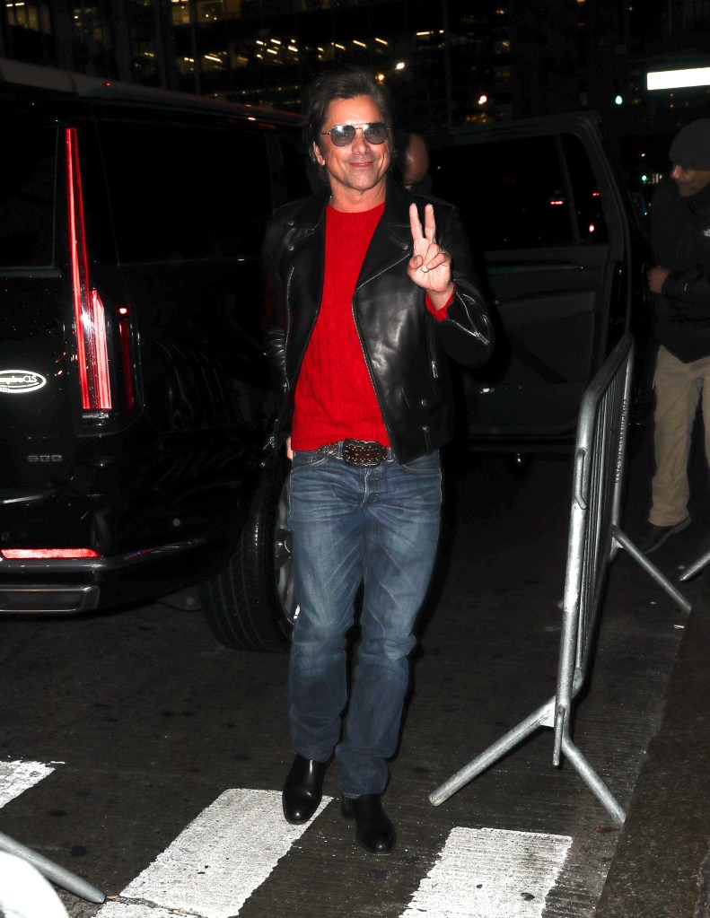 John Stamos arriving for his appearance at The Tonight Show, throwing a peace sign to the paparazzi.