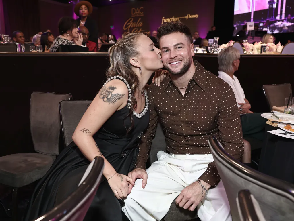 JoJo Siwa kisses Chris Hughes on the cheek at the Dancers Against Cancer Gala.