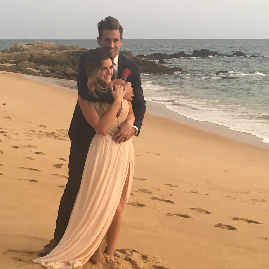 Jordan Rodgers and JoJo Fletcher embracing on a beach.