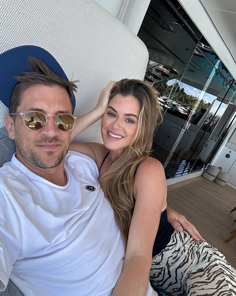 Jordan Rodgers and JoJo Fletcher sitting on a boat.