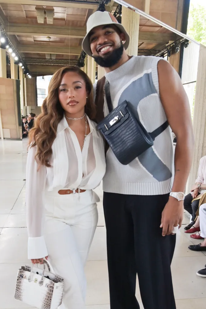 Jordyn Woods and Karl-Anthony Towns posing together at the Hermès SS26 Men's Show.