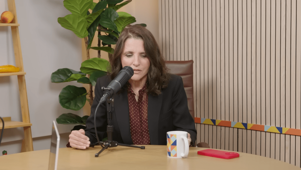 Julia Louis-Dreyfus speaking into a microphone.