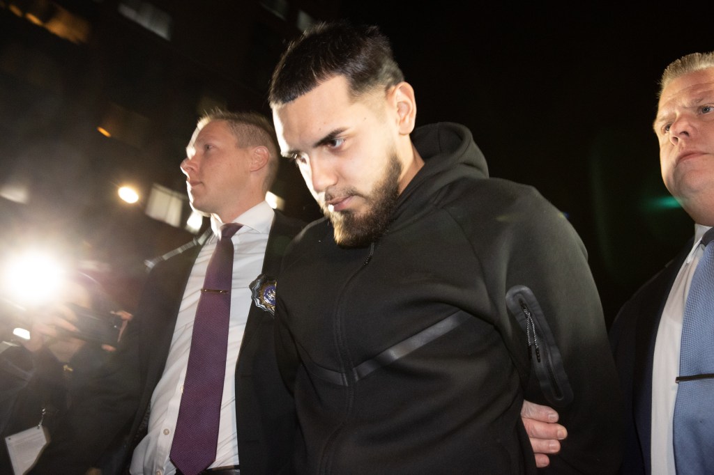 Justin Aguilera led out of the 109 Pct. in Queens following his arrest on gang assault, assault, riot and trespassing charges.