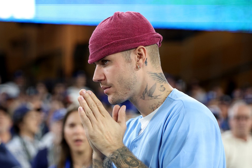Justin Bieber watches the World Series baseball game.