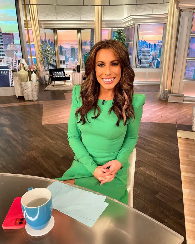 Alyssa Farah Griffin sitting at a table with a city skyline in the background.