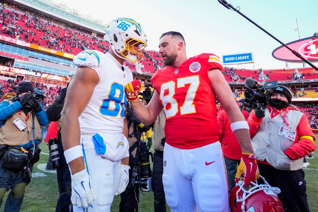 Kansas City Chiefs tight end Travis Kelce (87) talks with Los Angeles Chargers tight end Oronde Gadsden II (86) at GEHA Field.