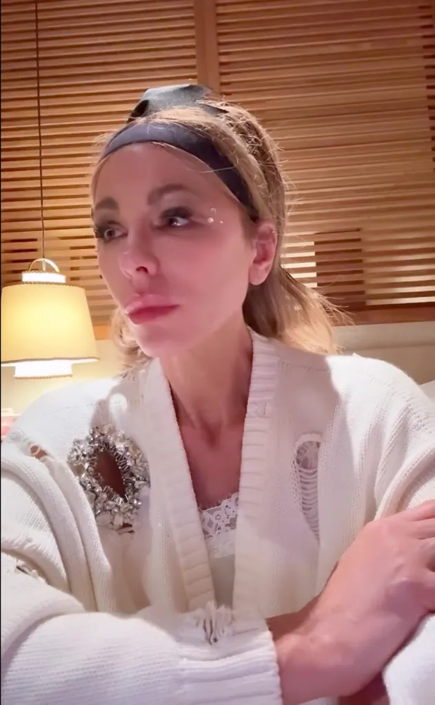 Kate Beckinsale wearing a white ripped cardigan and black headband.