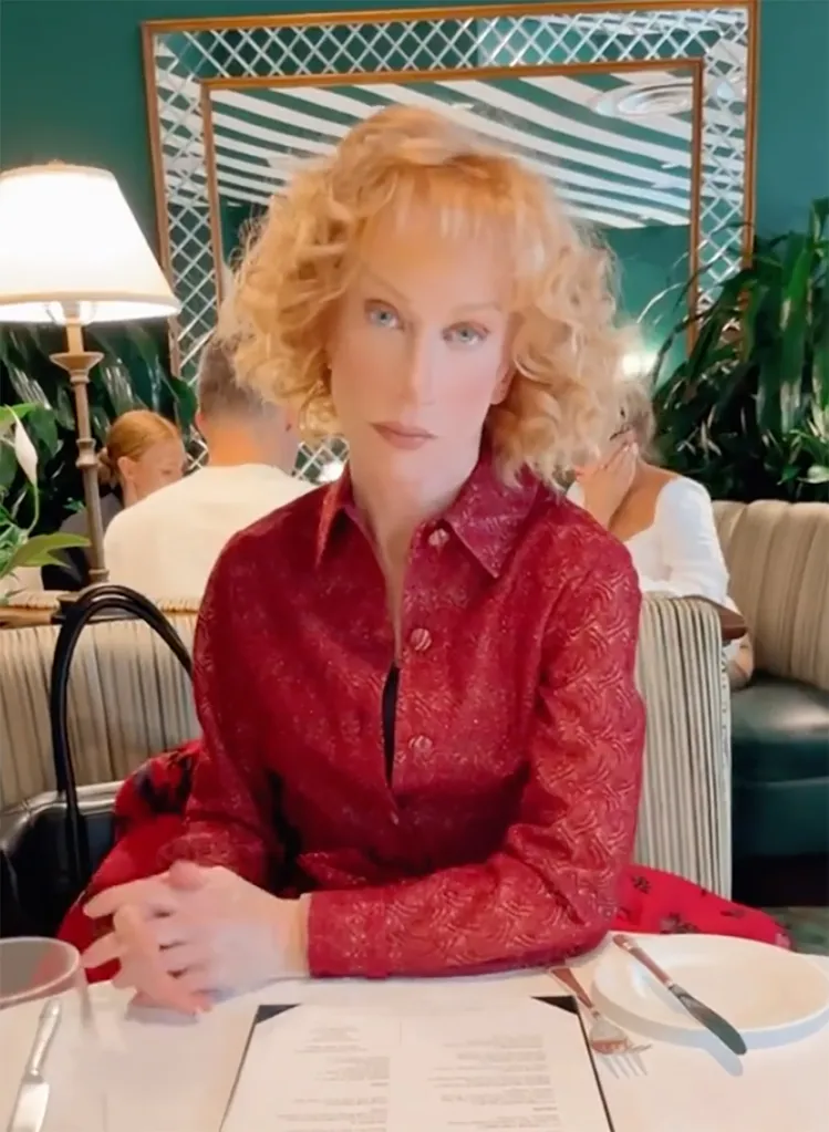Kathy Griffin sitting at a restaurant table.