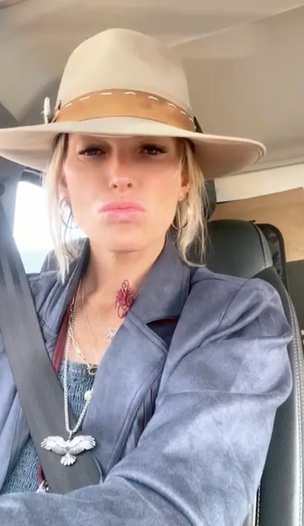 Kelley Wolf looking into the camera while wearing a wide-brimmed hat.