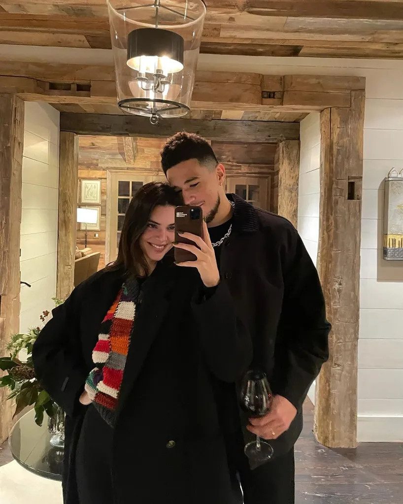 Kendall Jenner takes a selfie with Devin Booker, who is holding a glass of wine.
