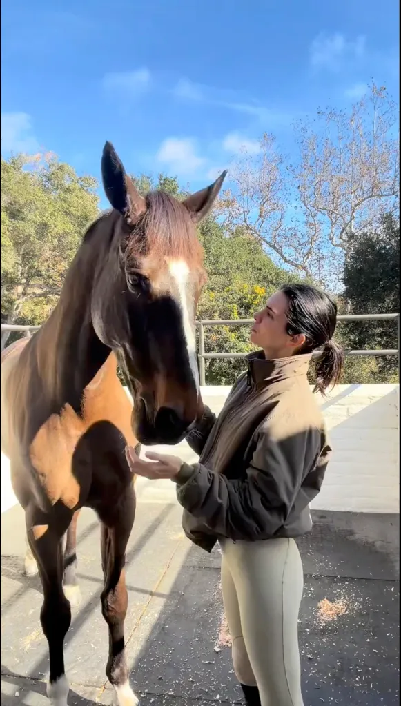 Kendall Jenner interacting with her horse.